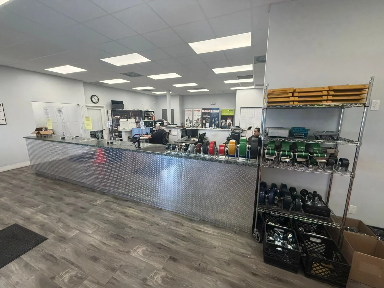 Sales counter at the Douglas Equipment Miami showroom — diamond-plate quote desk, wheel display rack, customer service area